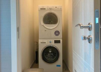 Laundry room with stacked washer and dryer