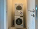 Laundry room with stacked washer and dryer