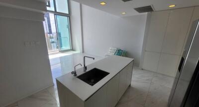 Modern kitchen with island sink and high ceilings