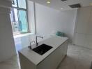 Modern kitchen with island sink and high ceilings