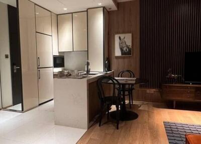 Modern kitchen and dining area with integrated cabinets and wooden accents