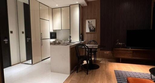 Modern kitchen and dining area with integrated cabinets and wooden accents