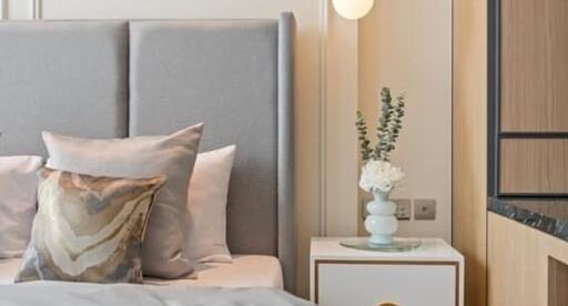 Modern bedroom with a stylish headboard and bedside table