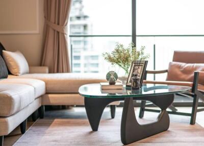 Modern living room with large window, sofa, and coffee table