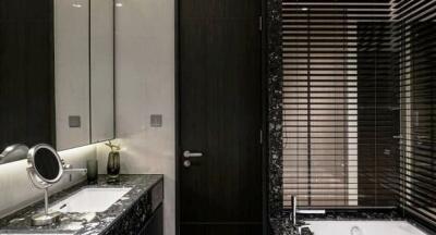 Modern bathroom with dark wood accents and marble countertops