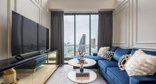 Modern living room with blue sofa and large window