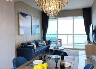 Elegant living room with dining area and decorative chandeliers
