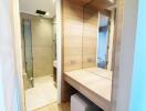 Modern bathroom with wooden vanity and a glass shower enclosure