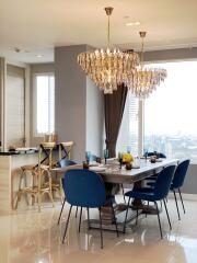 Modern dining room with chandelier, dining table, and chairs.