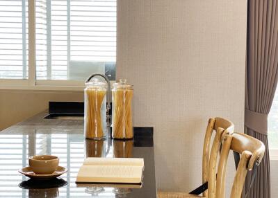 Modern kitchen with a black countertop and bar stools