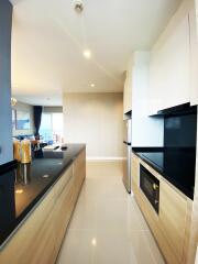 Modern kitchen with built-in appliances and a glossy black countertop