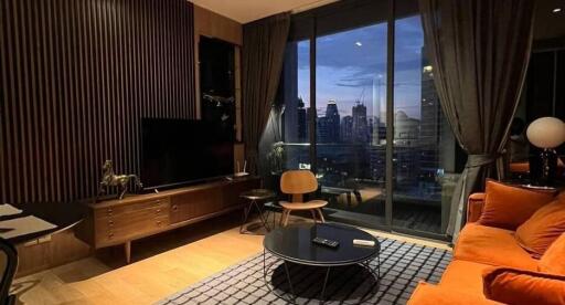 Modern living room with city view at dusk