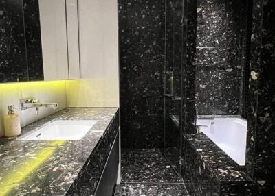 Modern black marble bathroom with illuminated vanity