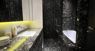 Modern black marble bathroom with illuminated vanity