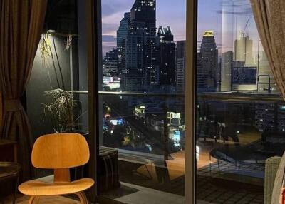 Living room with a view of the city skyline at dusk