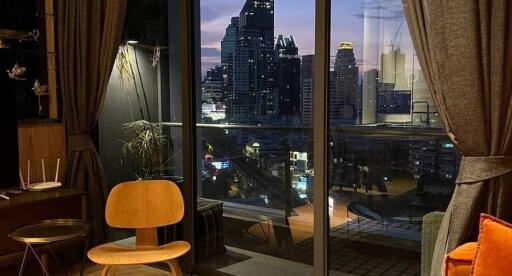 Living room with a view of the city skyline at dusk