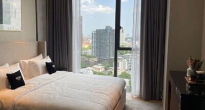 Modern bedroom with large window and city view