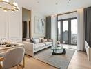 Modern living room with a sofa, dining area, glass coffee table, and city view.