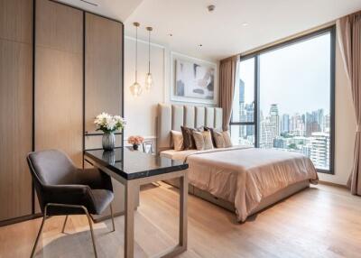 Modern bedroom with city view, featuring cozy decor and furniture