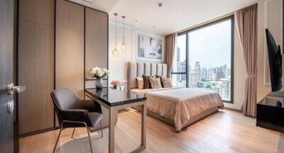 Modern bedroom with city view, featuring cozy decor and furniture