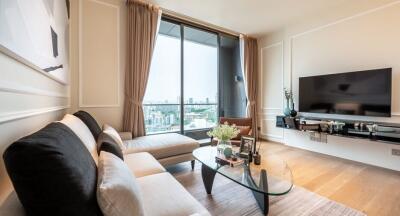 Modern living room with large window, corner sofa, and wall-mounted TV