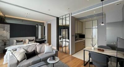 Modern open-plan living area with bedroom, kitchen, and dining area