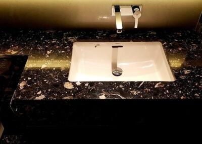 Modern bathroom sink with dark marble countertop