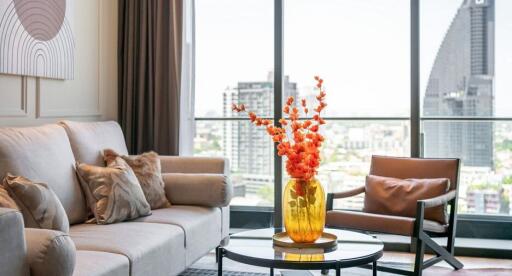 Modern living room with a large window and city view