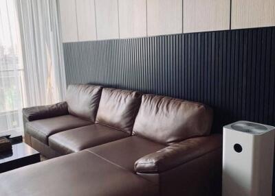 Modern living room with brown leather sofa and air purifier