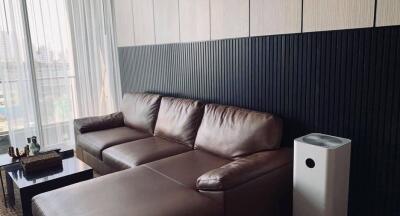 Modern living room with brown leather sofa and air purifier