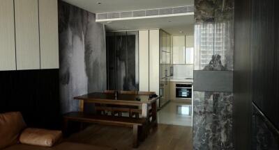 Modern kitchen and dining area with wooden table and wall panels