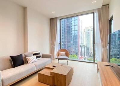 Modern living room with large window overlooking city buildings