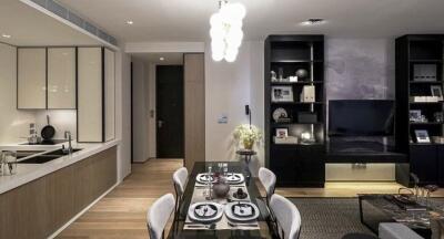 Modern dining room and kitchen area with a dining table and elegant lighting