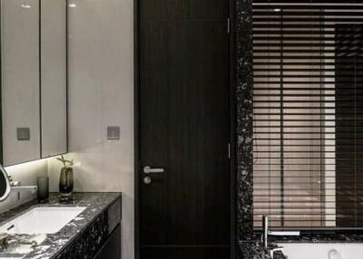 Modern bathroom with dark marble countertops and blinds