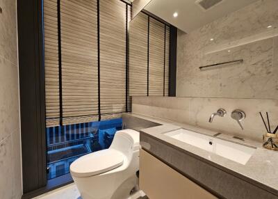Modern bathroom with large windows and marble walls