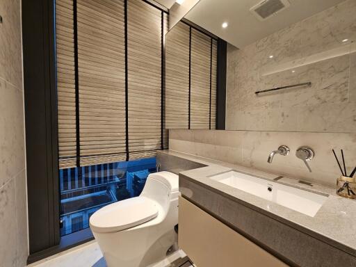 Modern bathroom with large windows and marble walls