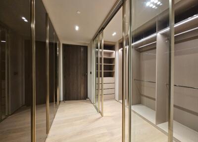 Modern walk-in closet with ample storage and lighting