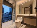 Modern bathroom with glass shower and city view