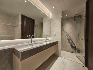 Modern bathroom with double sink and glass shower