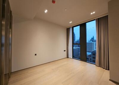 Spacious modern living room with large windows and city view