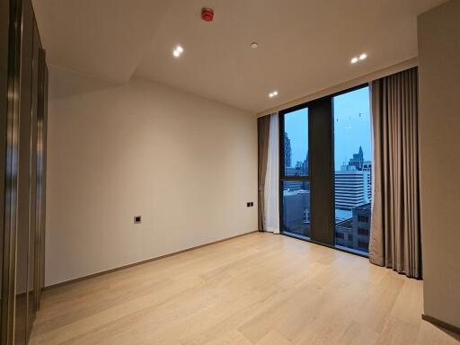 Spacious modern living room with large windows and city view