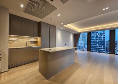 Modern kitchen and living area with large windows
