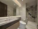 Modern bathroom with marble walls and glass shower