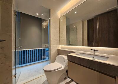 Modern bathroom with glass shower and large mirror