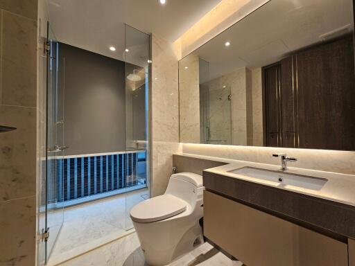 Modern bathroom with glass shower and large mirror