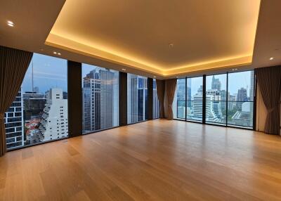 Spacious modern living room with large windows and stunning city views