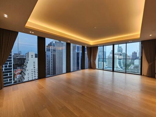 Spacious modern living room with large windows and stunning city views