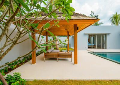 Cozy outdoor seating area beside a swimming pool