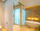 Bathroom with modern design, featuring a freestanding bathtub and a glass shower