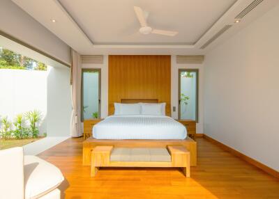 Spacious bedroom with wooden furniture and natural lighting
